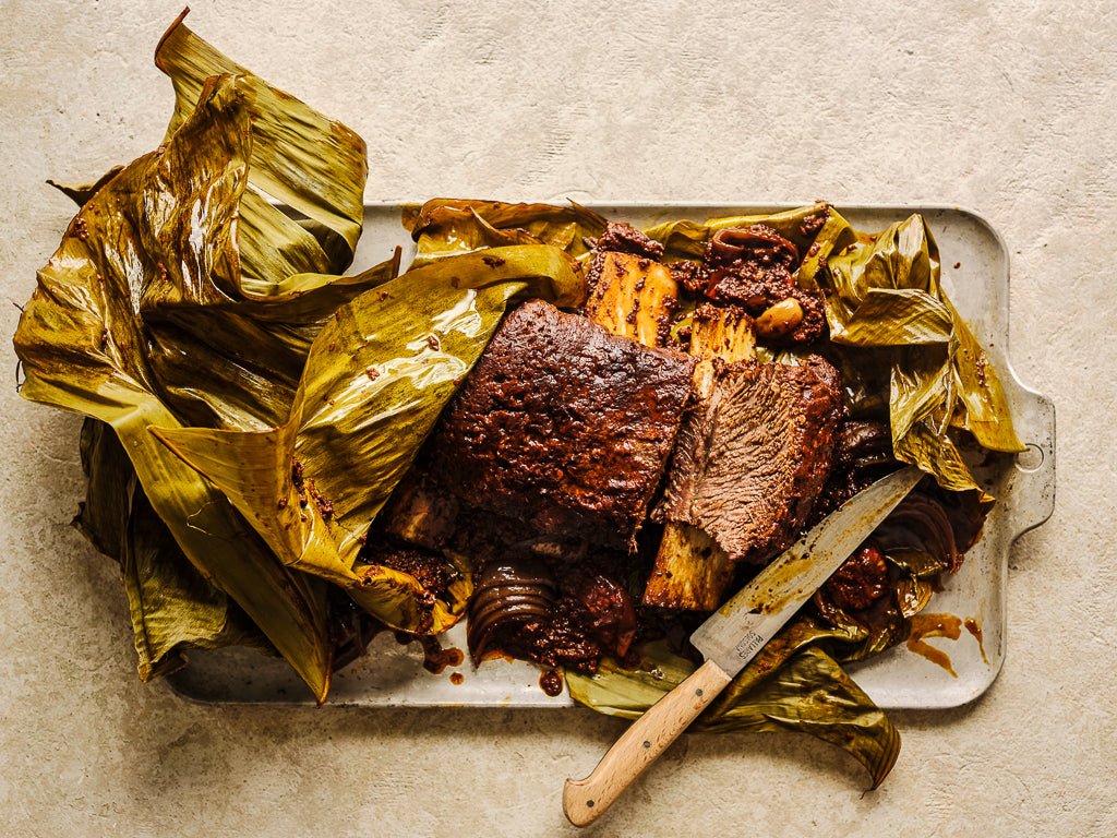 jacobs ladder mexican style with ancho and chipotle marinade slow cooked in banana leaves (cooked dish)