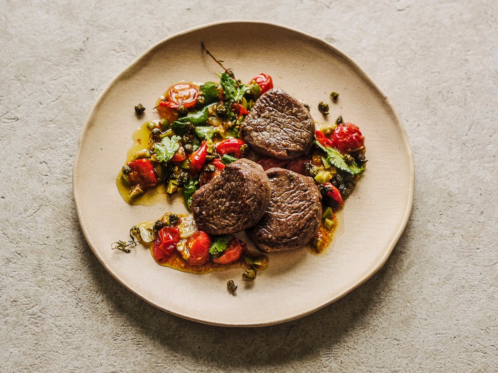 fillet steak medallions pan fried with sauce vierge (cooked dish)