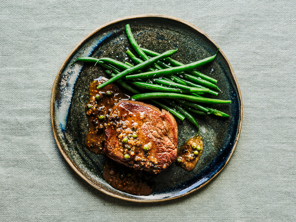 served with sherry green peppercorn and grain mustard sauce and green beans (cooked dish)