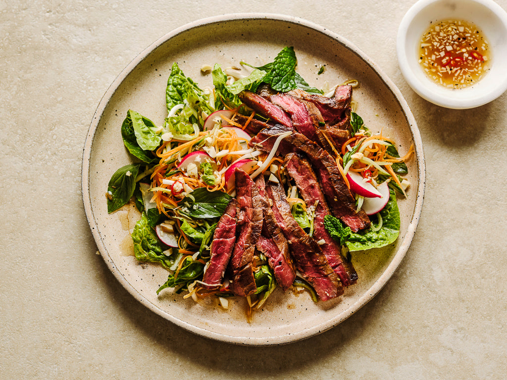 topside minute steak pan fried over high heat thinly sliced and served as a thai salad (cooked dish)